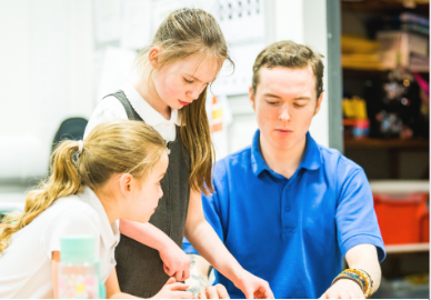 Teacher supporting a pupil with physical disability